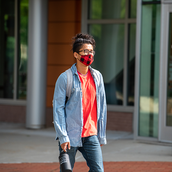 masked student on campus