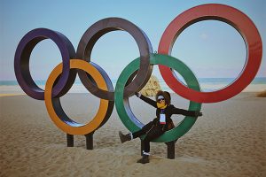 Casey Silvestri sitting on olympic rings