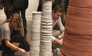 Students looking at sculpture installation