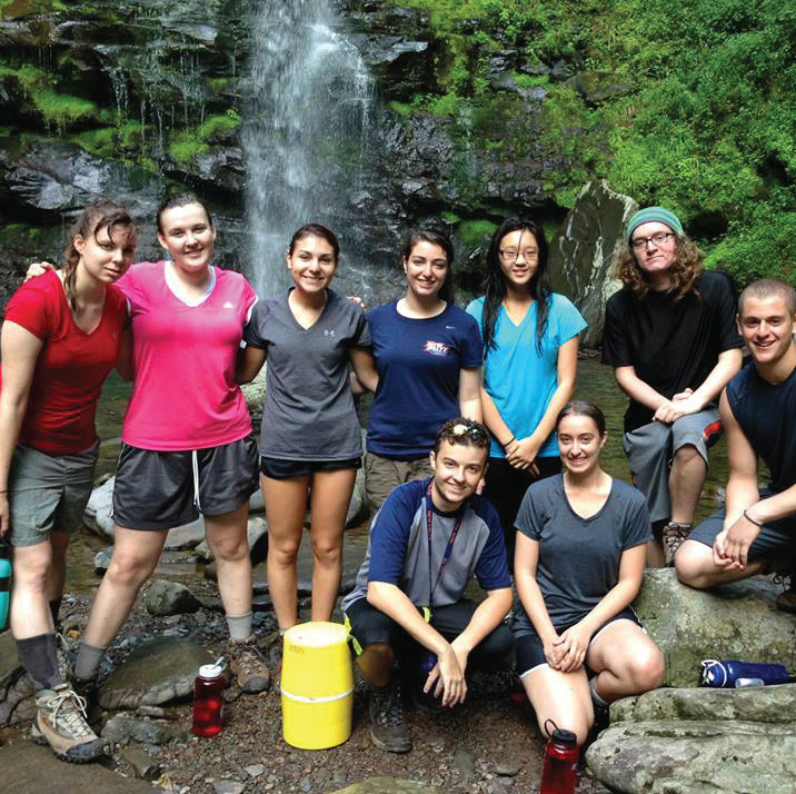 students hiking stop for a candid photo