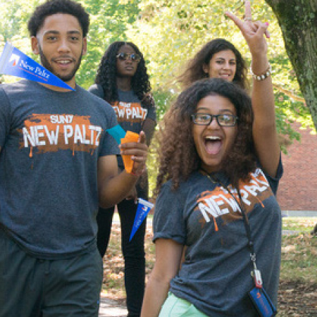 Students cheering with New Paltz Swag