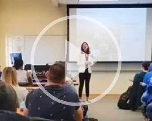 Student giving a presentation in front of a classroom