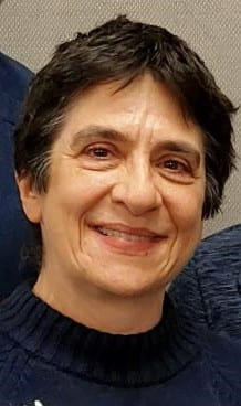 smiling woman with short brown hair