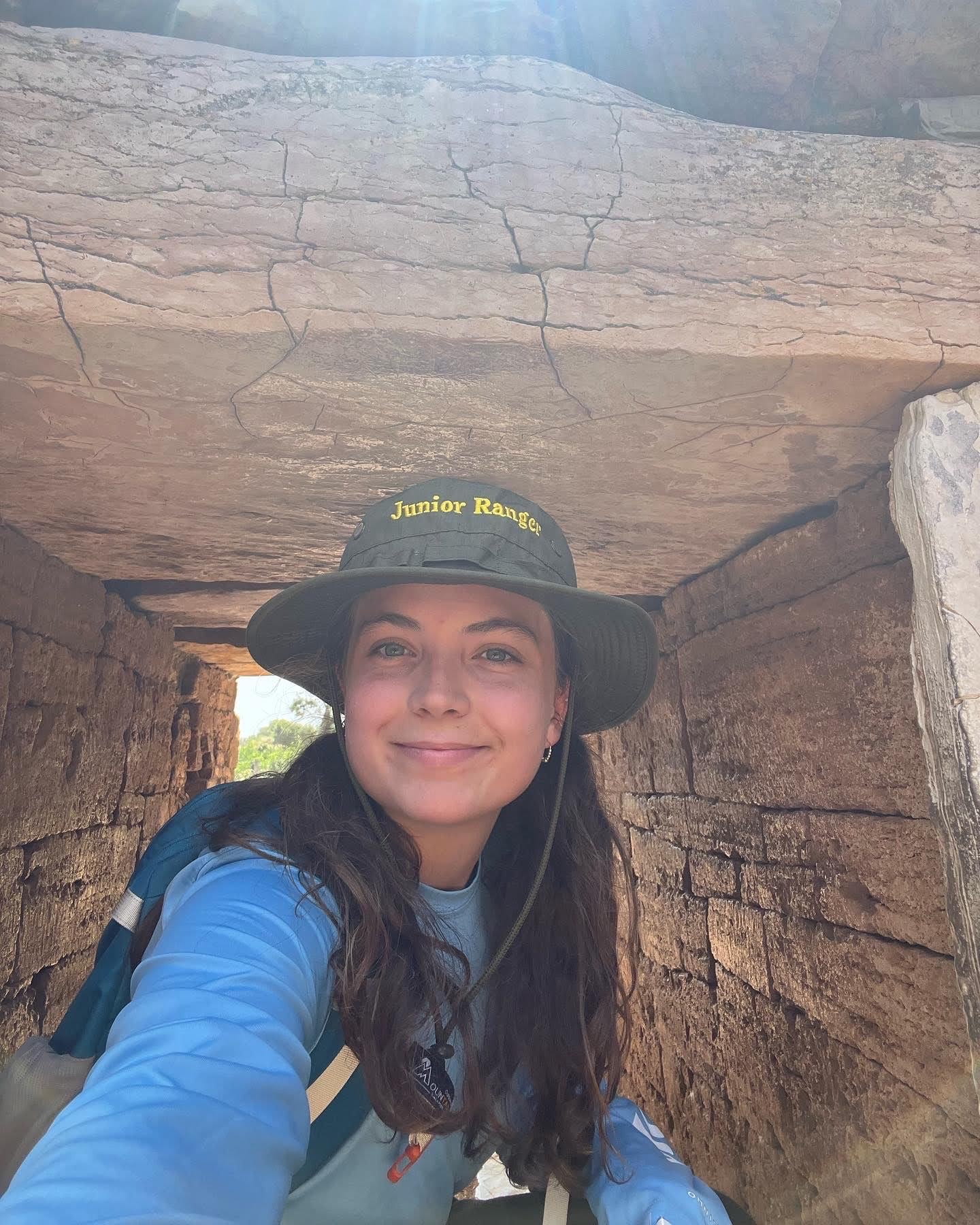 young woman with hat at an archaeological site