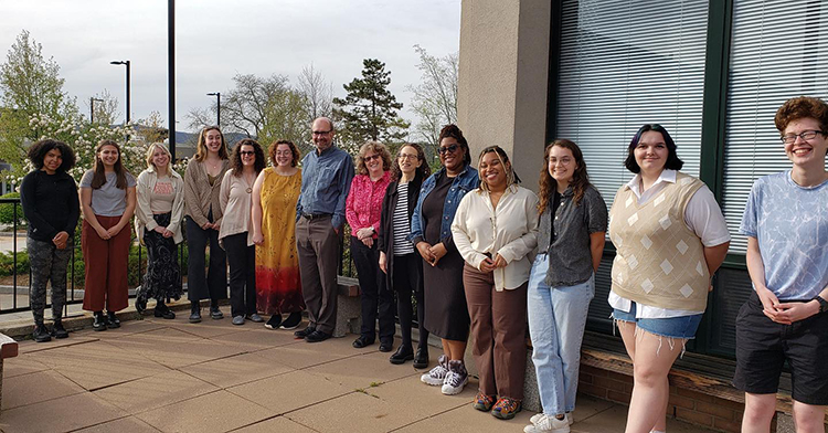 students and faculty outside on the College Theatre patio