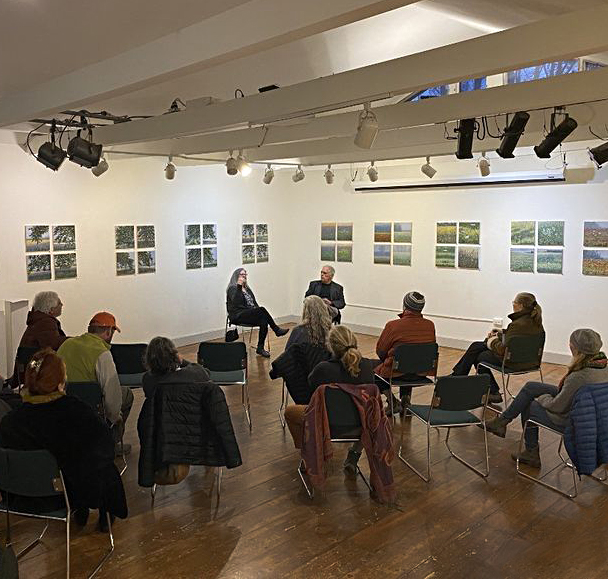 people talking in an art gallery