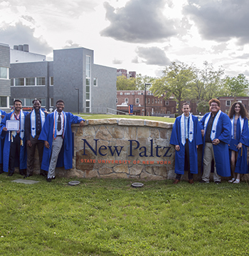 AC2 Ceremony group shot of recipients in front of campus