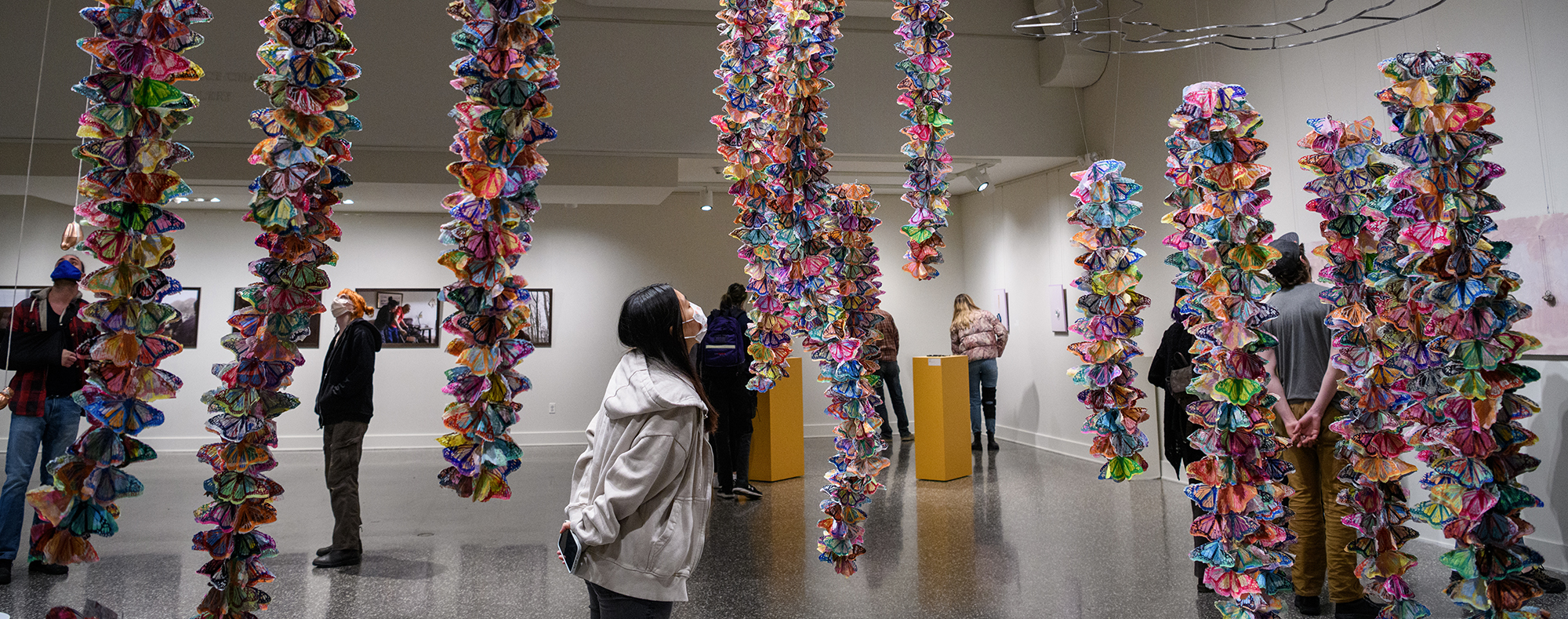 Student looking artwork at the BFA Thesis Show in The Dorsky