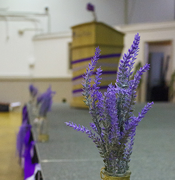 Podium and stage decorated with lavender and streamers