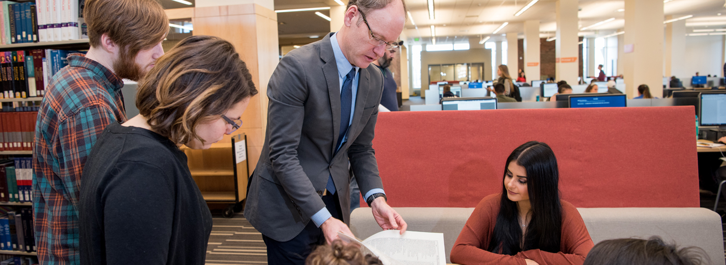 Cyrus Mulready and students in the library