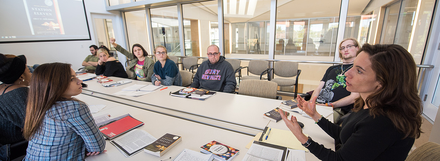 professor and students looking at smart screen in classroom