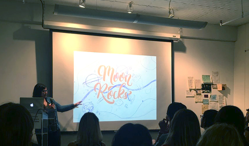 A woman presenting in front of an audience