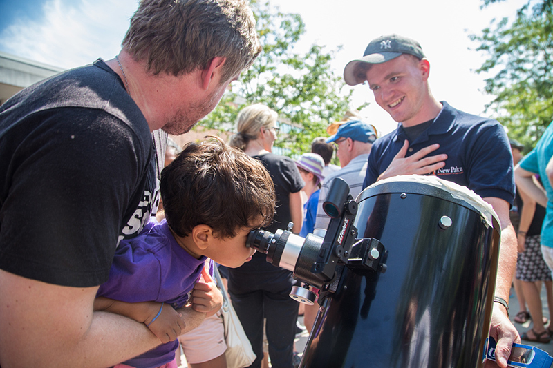 Child looking through special telescope