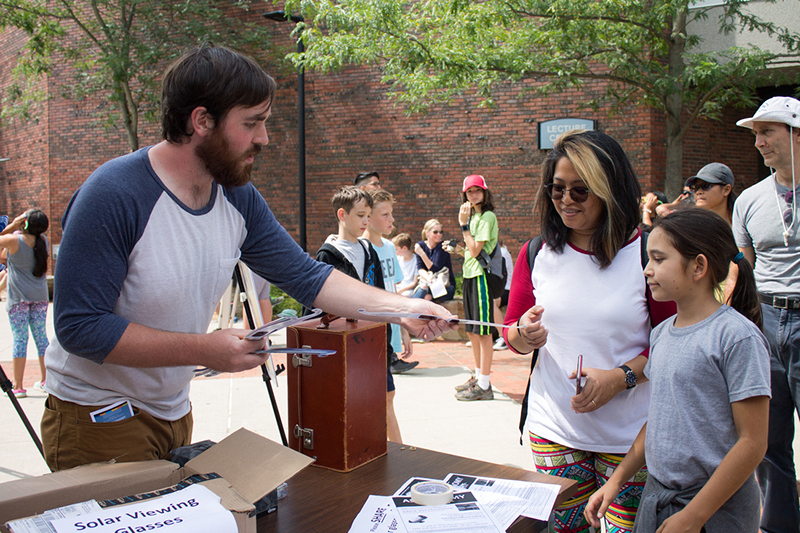 Organizers handing out special glasses