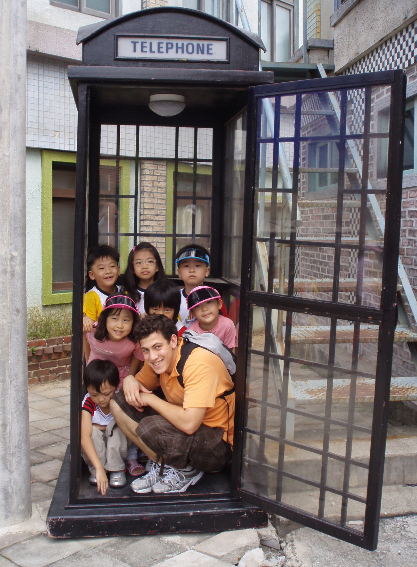 adam in a phonebooth with his students