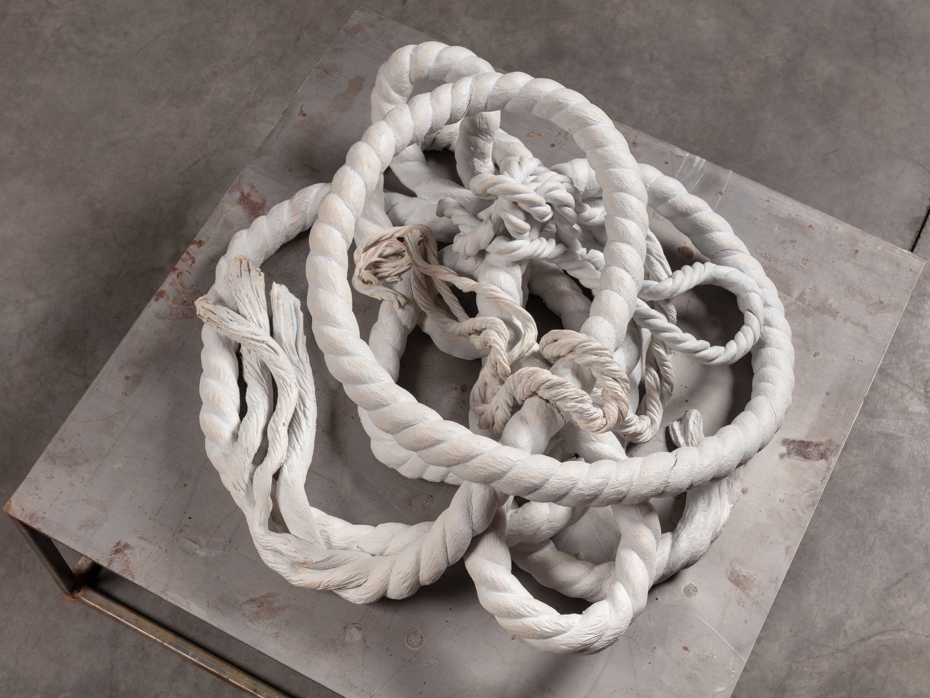 Black and white photo of white rope messily coiled