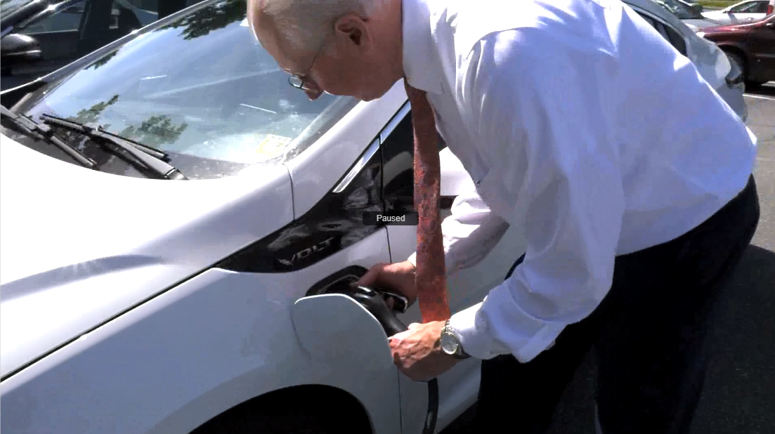 President Christian charging his electric car